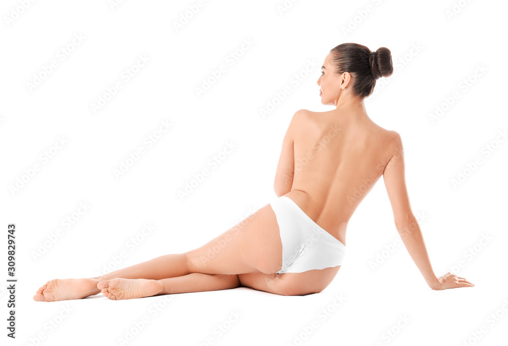 Doing exercises for the spine. Young woman in underwear is in the