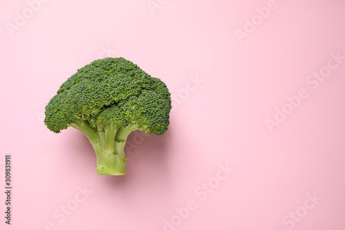 Fresh tasty broccoli on pink background, top view. Space for text
