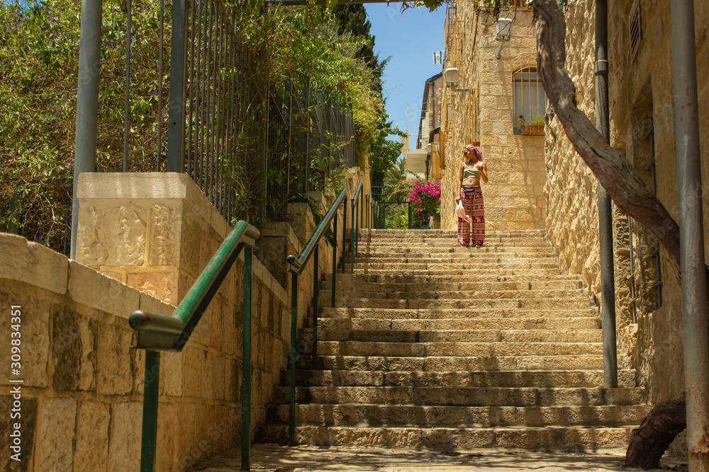 candid travel girl photography on stairway back street alley of Jerusalem old city in spring time candid travel girl photography on stairway back street alley of Jerusalem old city in spring time