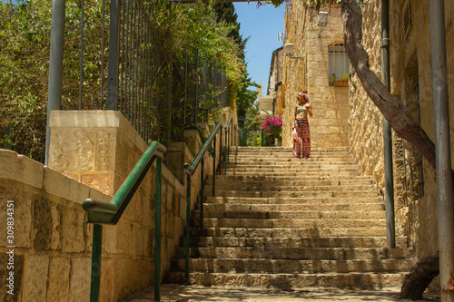 candid travel girl photography on stairway back street alley of Jerusalem old city in spring time