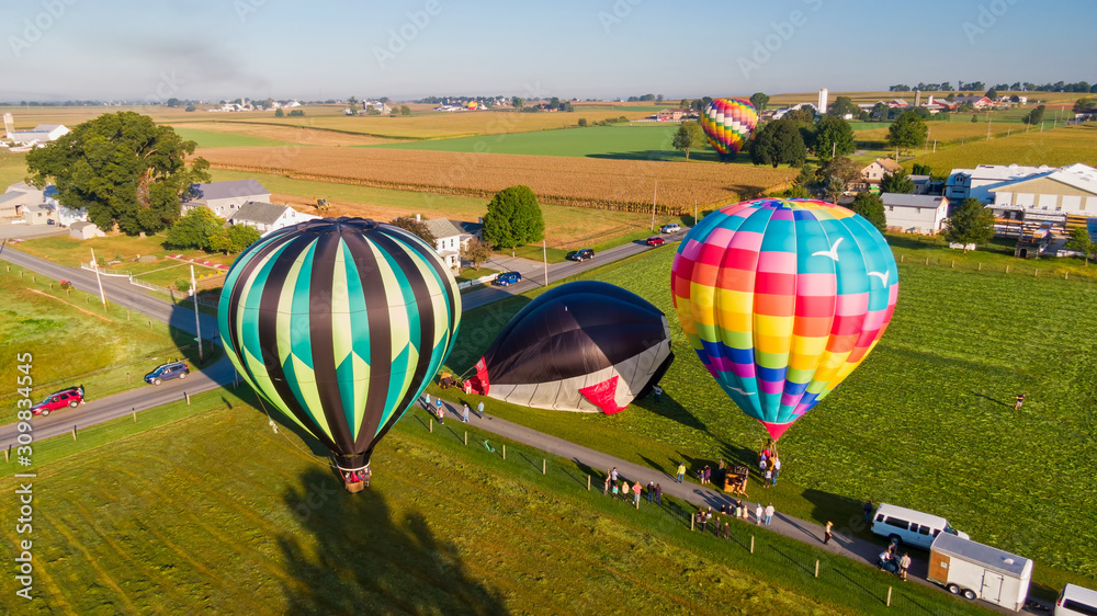 Fototapeta premium Hot air balloons rise into the air above American countryside in Pennsylvania