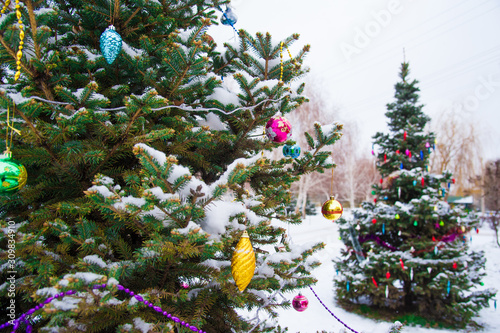 Christmas tree with decoration under snow