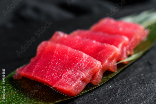 sashimi tuna on a stone Board. Black background. Top view. Close up