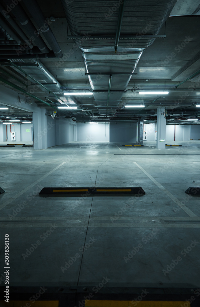 Vertical image of empty underground parking lot Vertical image of empty underground parking lot
