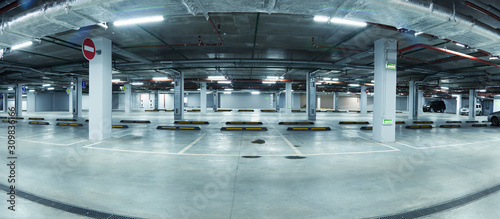 Panoramic image of new clean underground parking lot