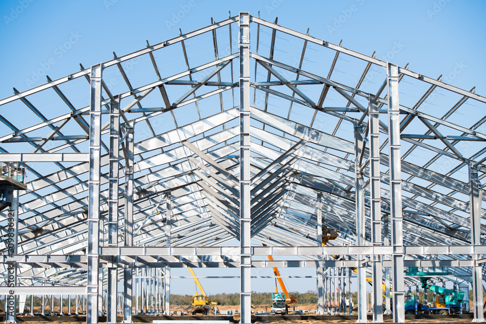 Steel frame workshop is under construction against a blue sky Steel frame workshop is under construction against a blue sky