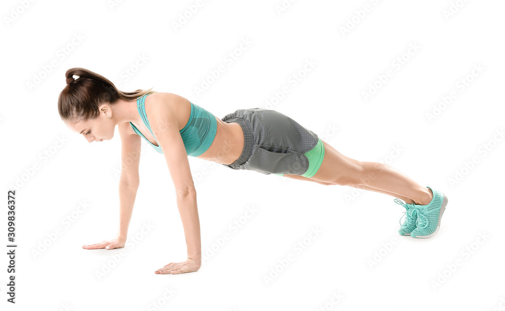 Sporty young woman training against white background