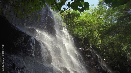 Scenic Kanto Lampo waterfall cascading down a stepped rock in Bali island Indonesia.