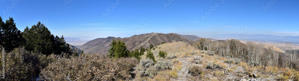 Rocky Mountain Wasatch Front peaks, panorama landscape view from Butterfield canyon Oquirrh range by Rio Tinto Bingham Copper Mine, Great Salt Lake Valley in fall. Utah, United States.