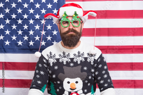 lets get started. Bearded american man celebrate new year. National us flag. Patriotic hipster celebrate winter holidays. All american xmas party. Christmas in usa. Santa on american flag background © be free
