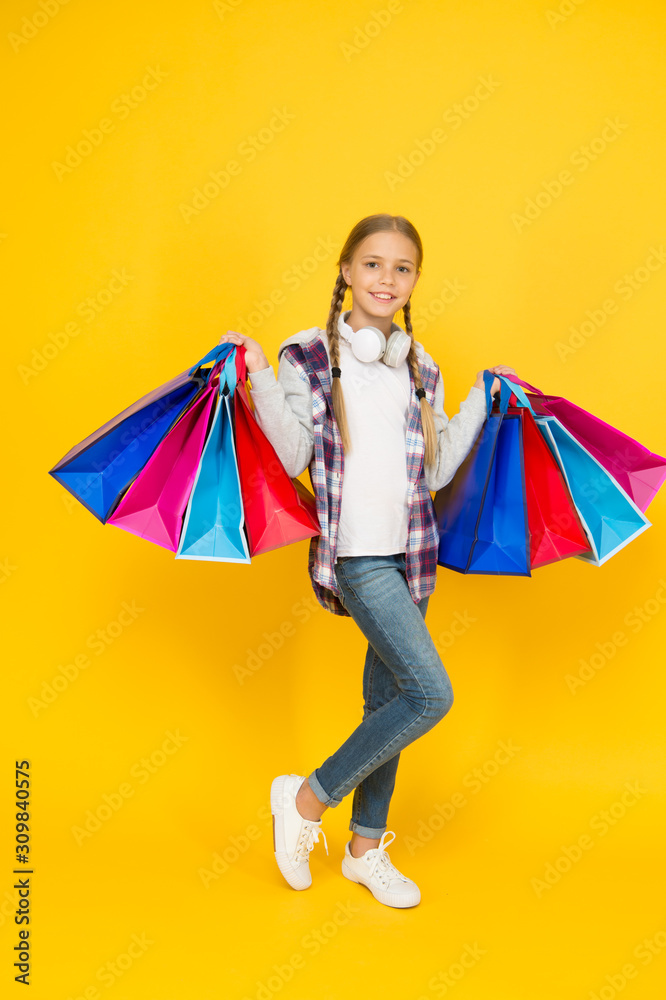 black friday. hurry up its total sale. Kids fashion. Sales and discounts. happy small girl after successful shopping. adorable child with heavy bags. Best outfit ever. holiday gifts in packages black friday. hurry up its total sale. Kids fashion. Sales and discounts. happy small girl after successful shopping. adorable child with heavy bags. Best outfit ever. holiday gifts in packages
