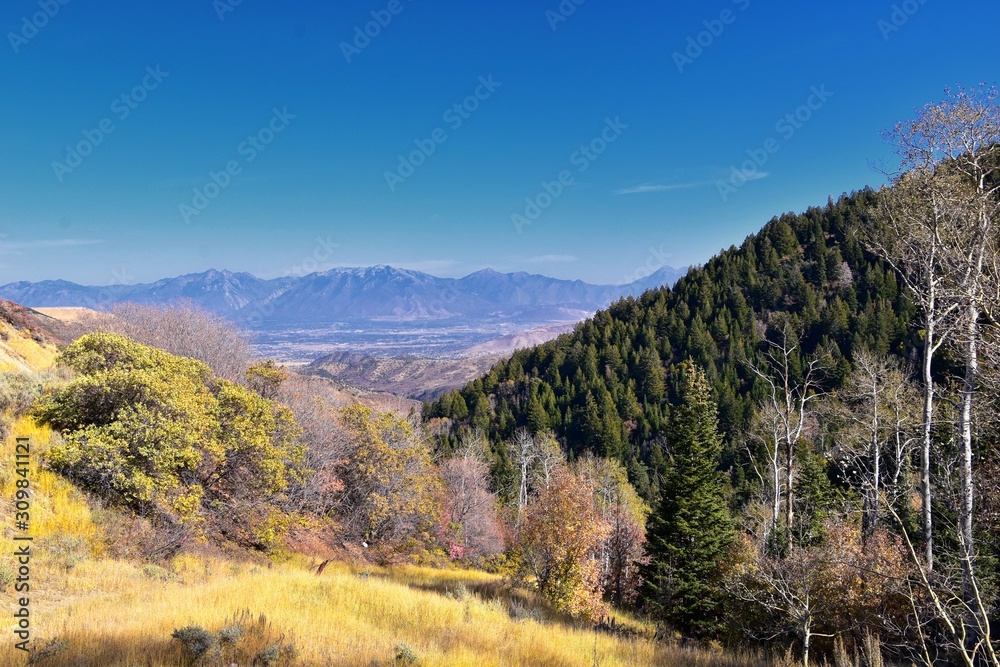 Rocky Mountain Wasatch Front peaks, panorama landscape view from Butterfield canyon Oquirrh range by Rio Tinto Bingham Copper Mine, Great Salt Lake Valley in fall. Utah, United States.