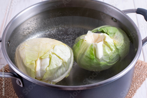 Ingredients for cooking cabbage rolls. Cabbage leaves in the pan