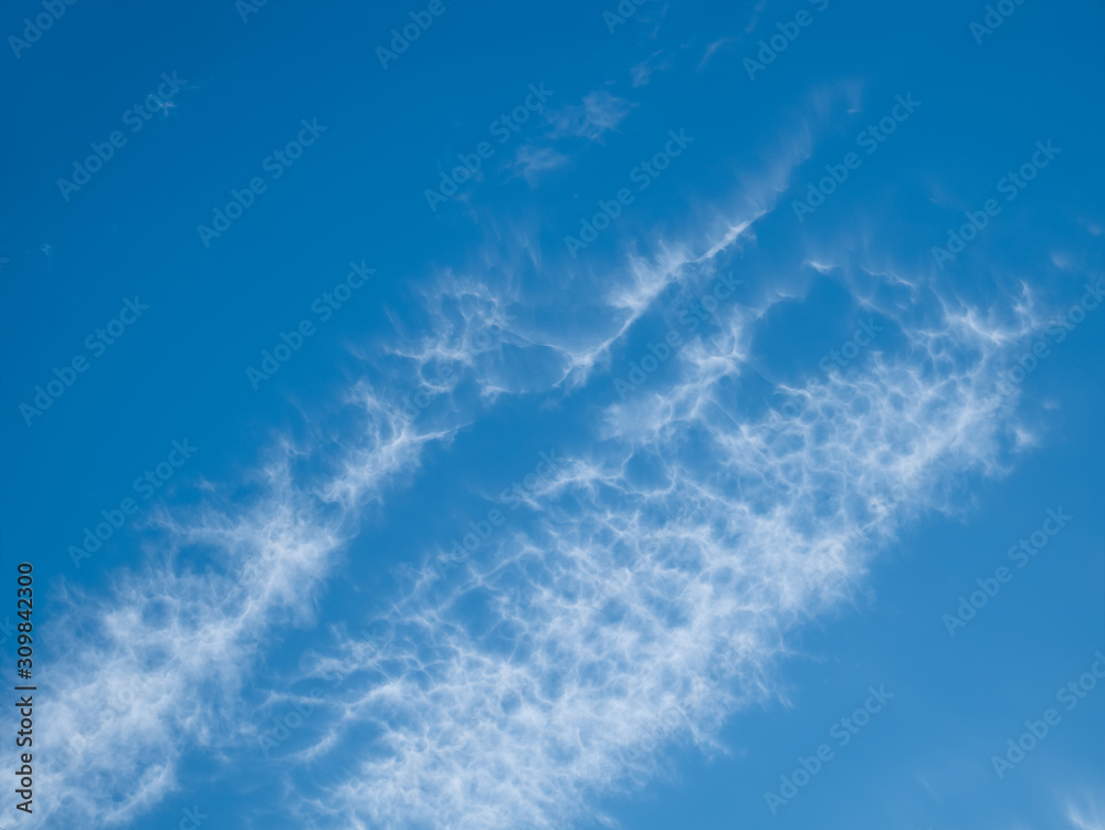 High white clouds in bright blue sky High white clouds in bright blue sky