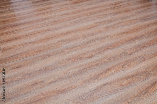 The floor of the light brown laminate diagonally
