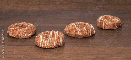 Cookies with white cream on dark wooden background_