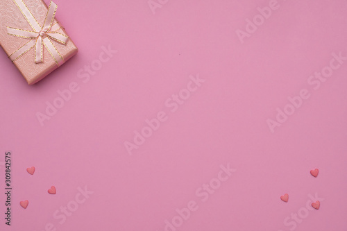 ..Romantic concept for Valentine`s Day. Flat lay. Pattern of pink hearts on a pink background and pink gift box.  Copy Space. © MIKHAIL