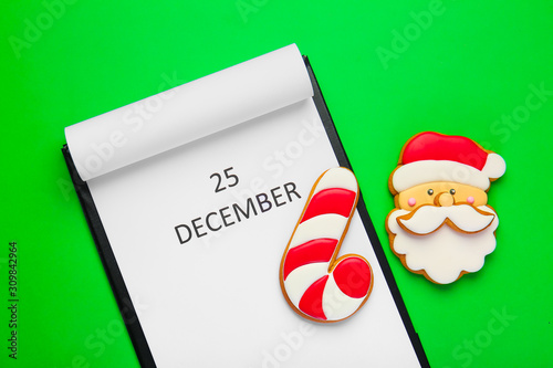 Calendar with date of Christmas on color background