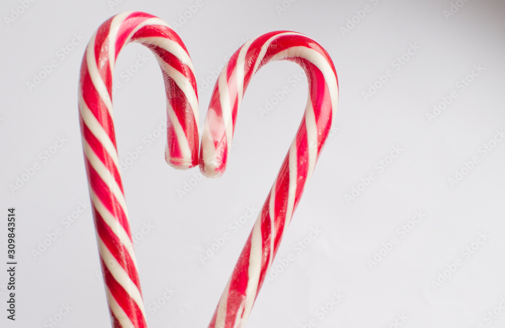 Fototapeta premium Christmas candy on a white background in the form of a heart, with free space for writing