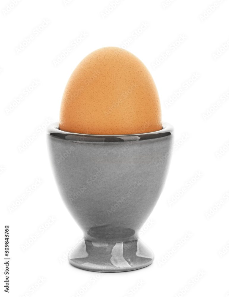 Holder with fresh egg on white background Holder with fresh egg on white background