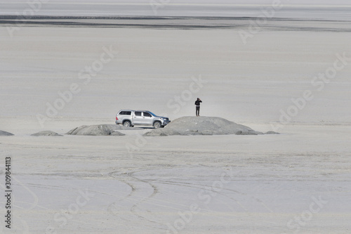 Man standing on top of the stone and watching. Makgadikgadi Pan , Botswana adventure