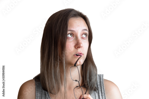 Portrait, woman in gray with black glasses under chin thinking hard, cogitative, needing to make tough decisions, isolated on white background photo