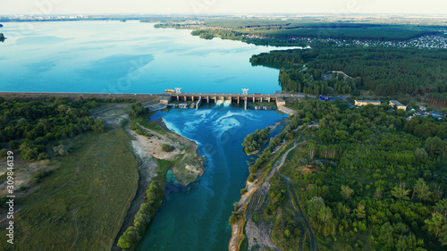 Fototapeta Naklejka Na Ścianę i Meble -  Aerial panorama of Dam at reservoir with flowing water, hydroelectricity power station, drone photo.