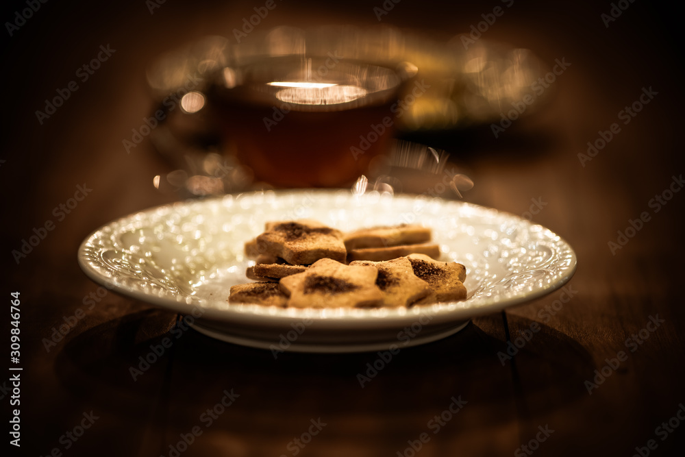 Tea cups with thin cream wafers. Teas with hot smoke. Fine cookies with accompanying special teas.