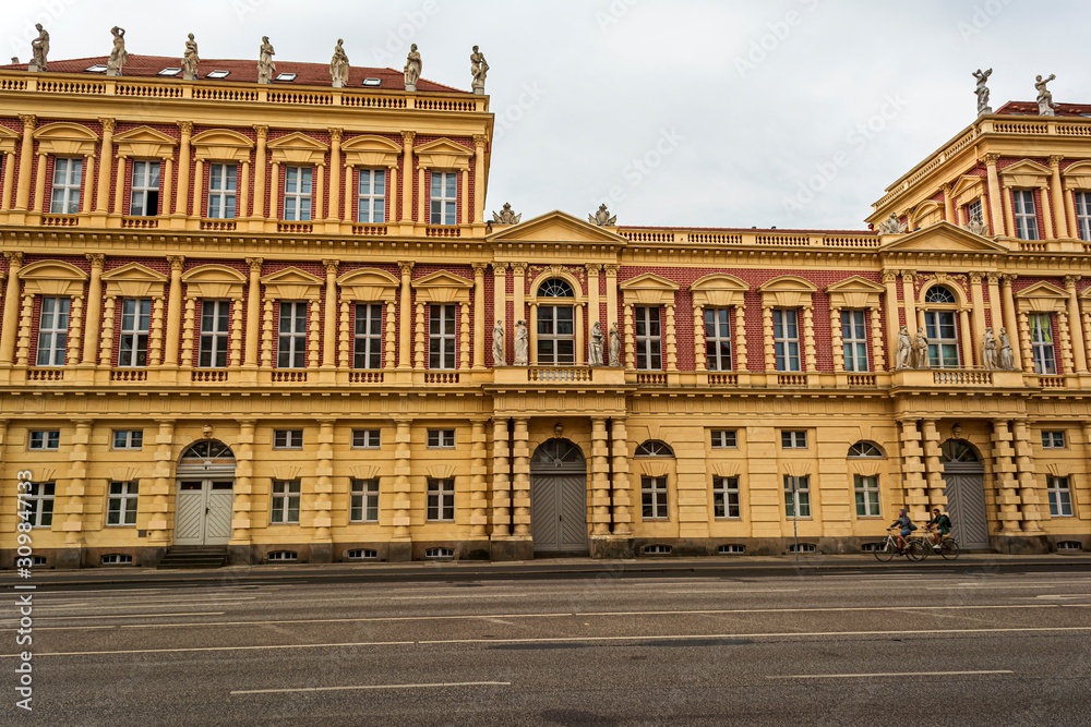 View of historical building in Potsdam, Germany with two cyclists