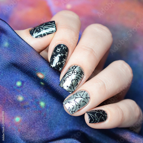 black and gray manicure with a constellation map pattern on a cosmic background