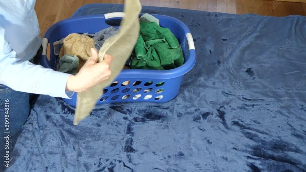 Woman folds laundry 4K Woman folds laundry 4K