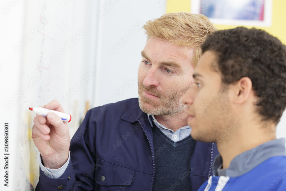 two male engineers working with new project two male engineers working with new project