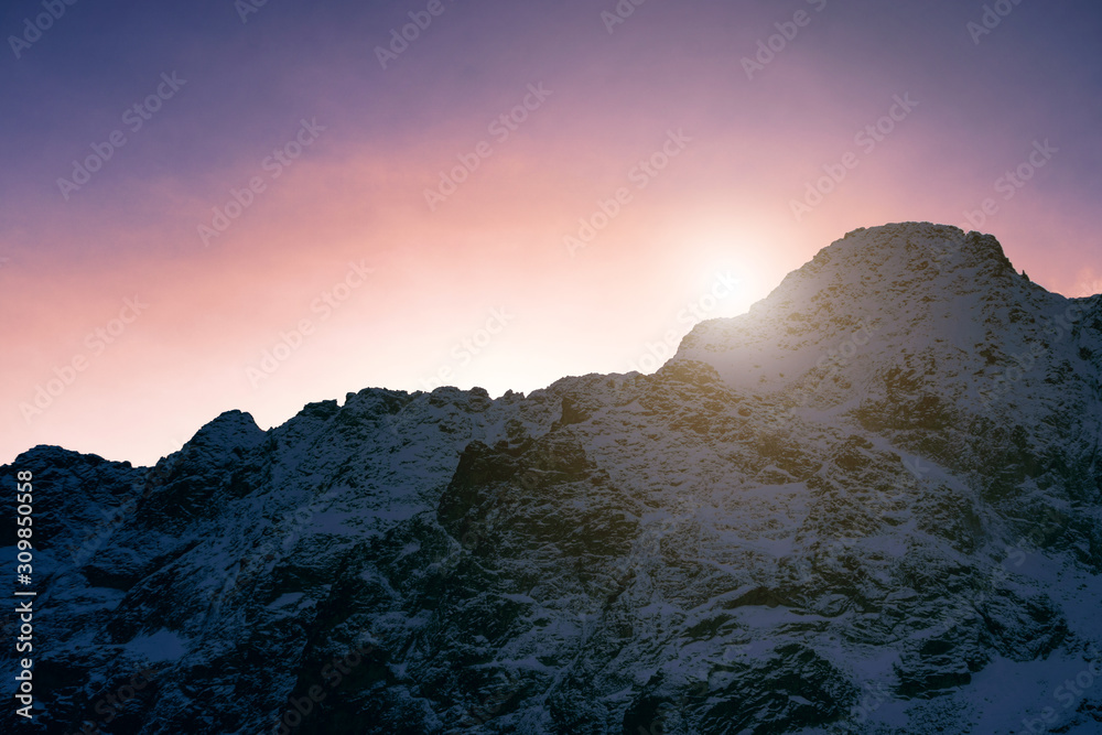 Sunset in the snowy mountains. Beautiful landscape in the mountains