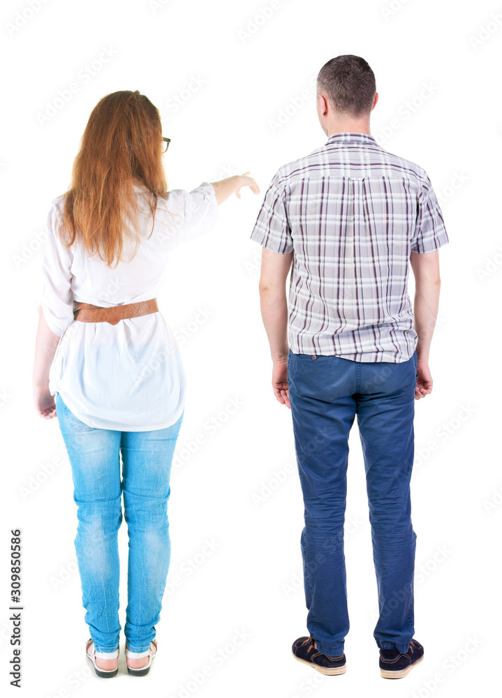 Back view of a stylish couple pointing. Back view of a stylish couple pointing.