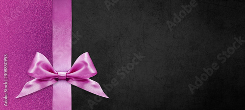 gift cards with pink ribbon bow Isolated on pink and black texture background, christmas and black friday template with copy space