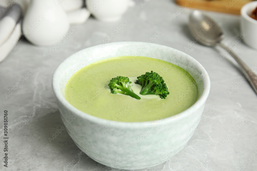 Delicious broccoli cream soup served on grey marble table Delicious broccoli cream soup served on grey marble table