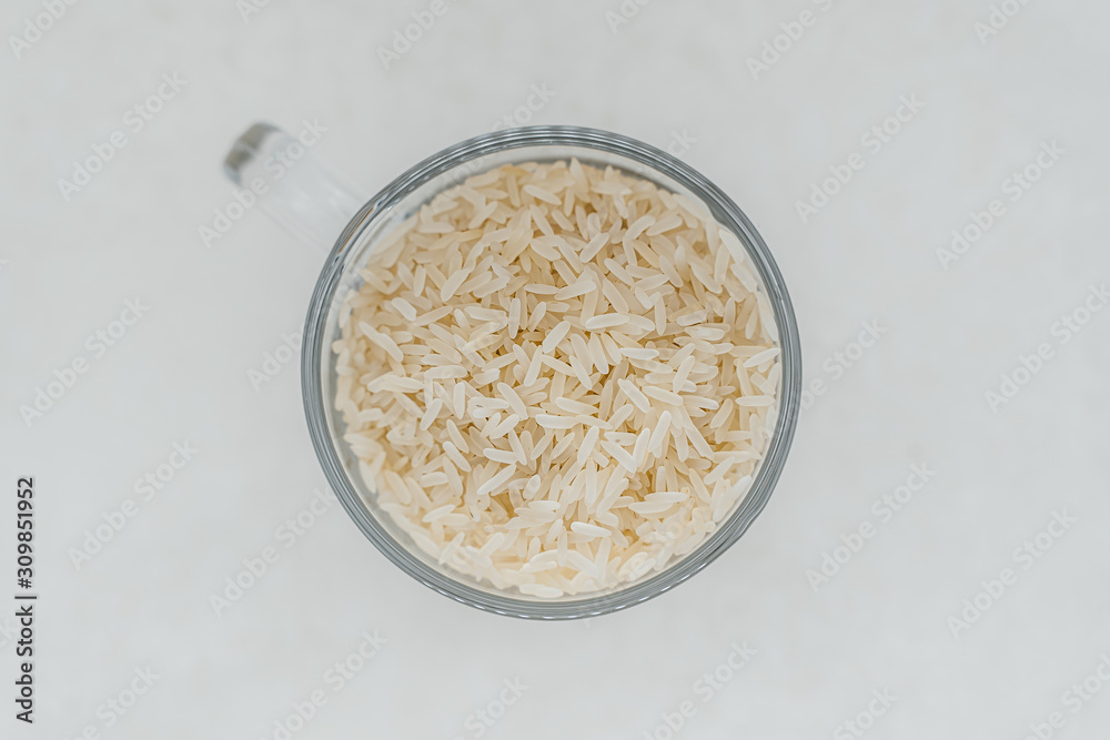 Rice in a glass mug on a white background Rice in a glass mug on a white background
