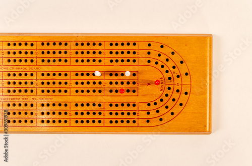 Overhead view of a cribbage board with pegs