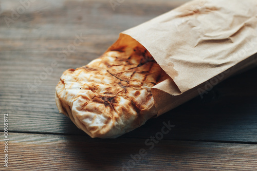 Doner Kebab Gyros Shawarma beef roll in pitta bread Wrap sandwich on wooden background. Copy space