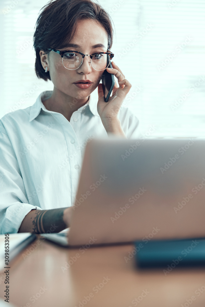 Young female worker is using mobile phone Young female worker is using mobile phone
