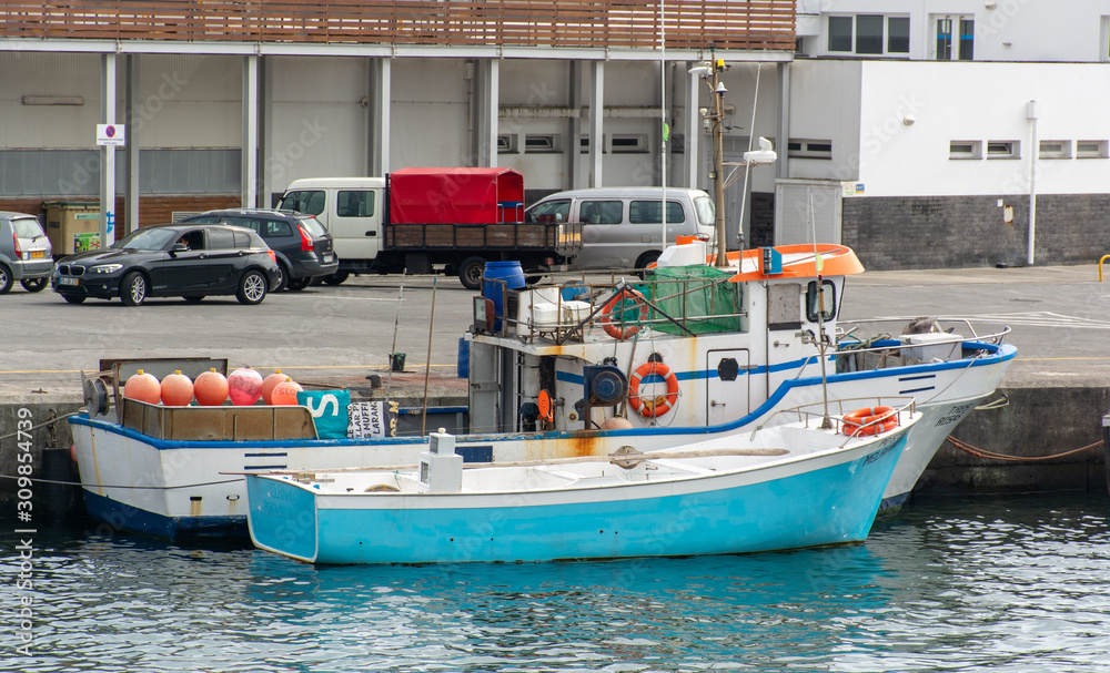 Fototapeta premium Colorful boats in the harbor at Ponta Delgada, Azores, Portugal