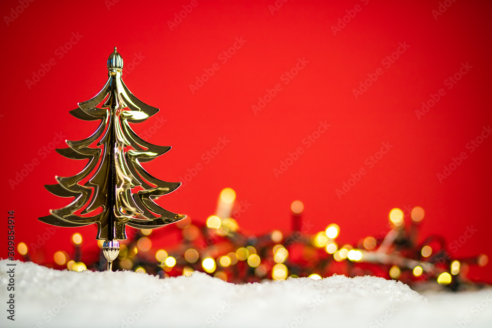 shiny golden Christmas tree on red background