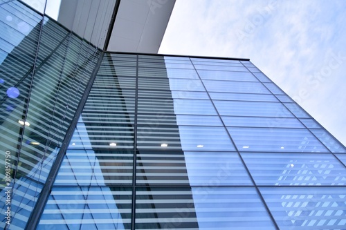 Abstract image of looking up at modern glass and concrete building. Architectural exterior detail of office building. 