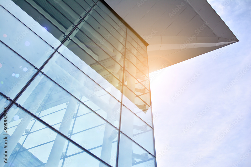 Sun rays light effects on urban buildings. Abstract image of looking up at modern glass and concrete building. Architectural exterior detail of office building. Sun rays light effects on urban buildings. Abstract image of looking up at modern glass and concrete building. Architectural exterior detail of office building.