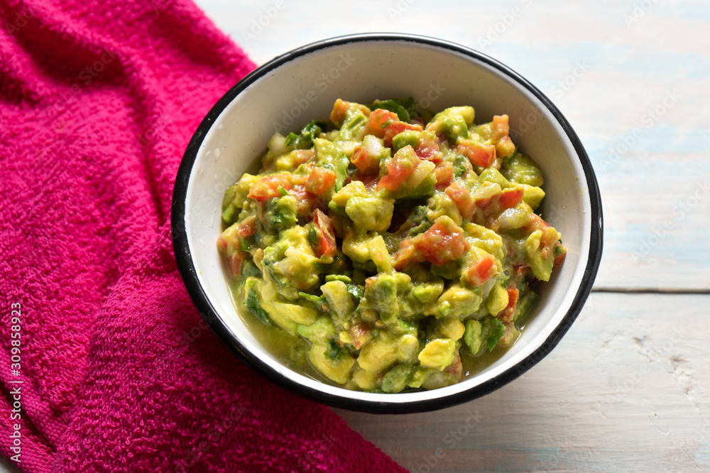 Mexican guacamole with tomato on white  background