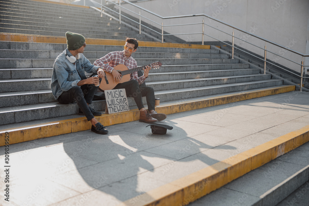 Two friends chatting with each other on the steps