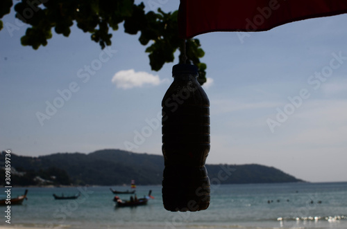 Plastic bottle hanging on beach
