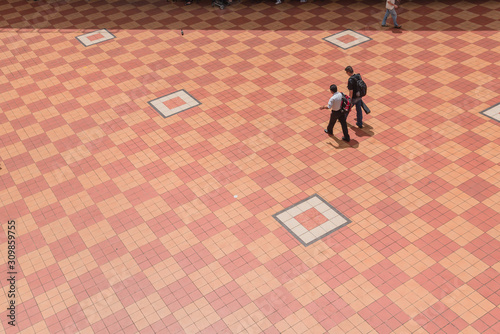 Photography Aerial view two Asian gentlemen walking on patio tiles outdoor in Singapore