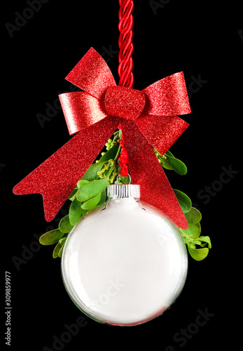 White Christmas ornament hanging by red ribbon rope with the bauble surrounde...