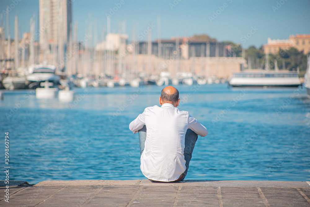 An old man watches the harbour of Marseille